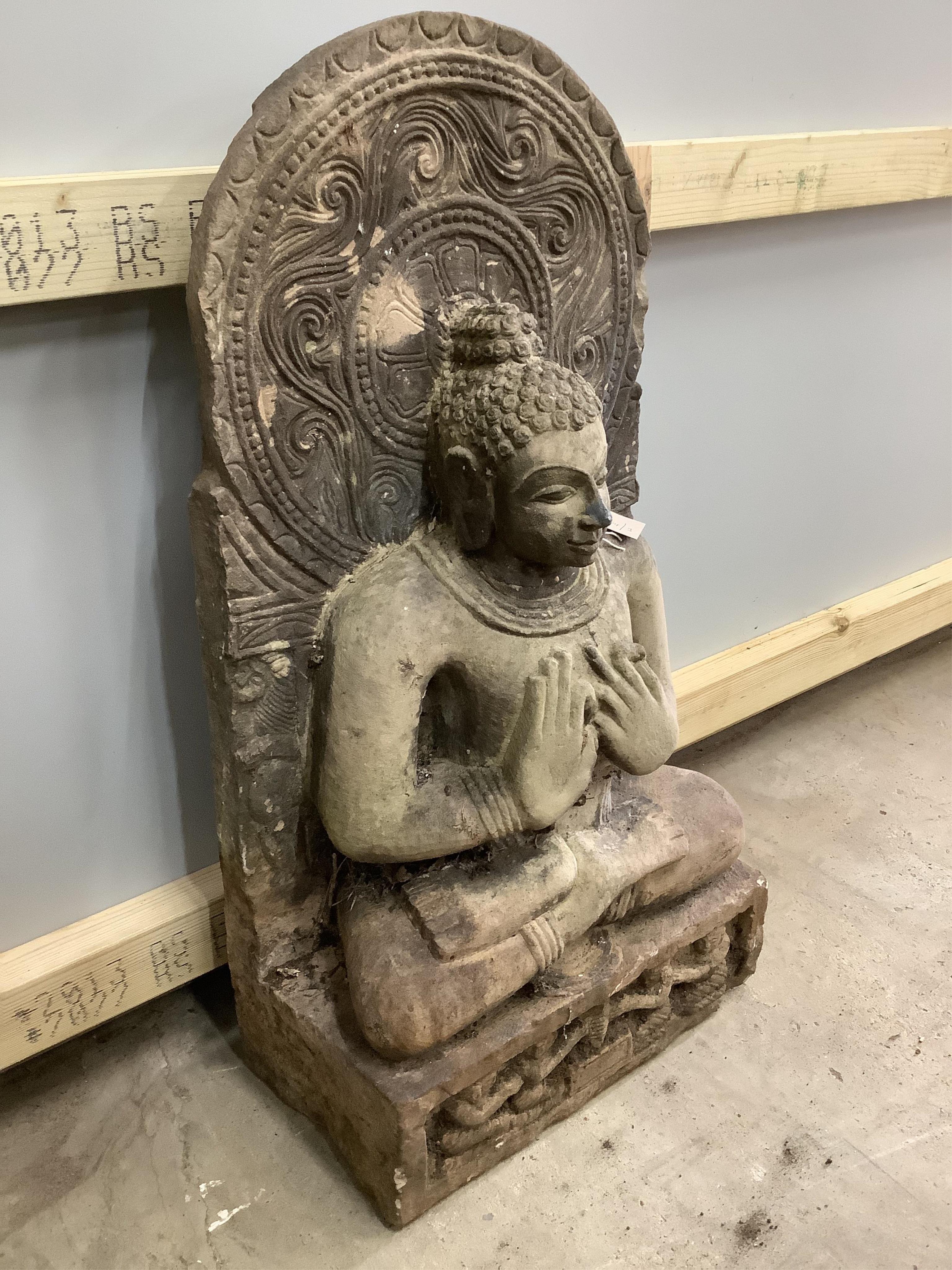 A South East Asian carved stone Buddha, width 39cm, height 79cm